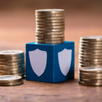 Stack Of Coins With Security Blocks On Wooden Block to illustrate high yield returns