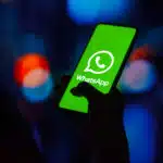 In this photo illustration, the WhatsApp logo is displayed on a smartphone screen